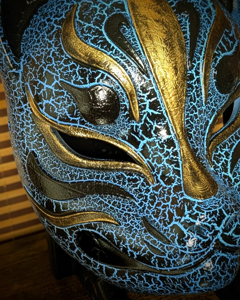 Handmade cracked blue Modern Kitsune mask by Dai Yokai, close-up of the face