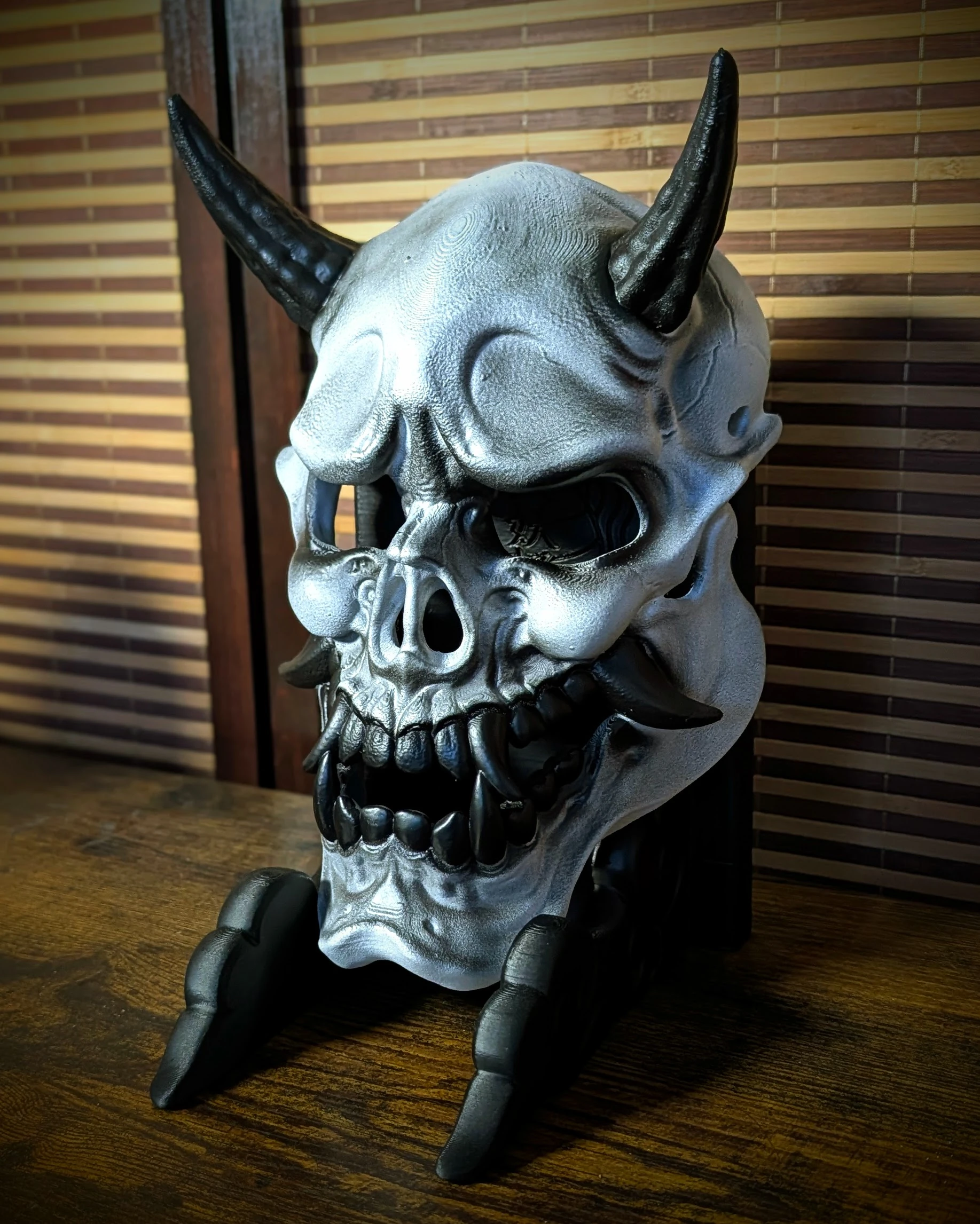 Silver and black Hannya skeleton mask, three-quarter view